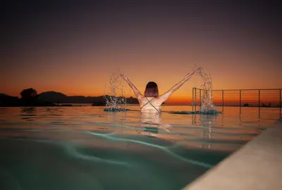 a woman in the water with her arms in the water at Villa Lombardo Luxury in Balestrate