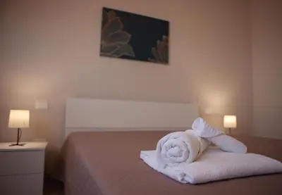 a pile of towels sitting on top of a bed at Villa Lombardo Luxury in Balestrate