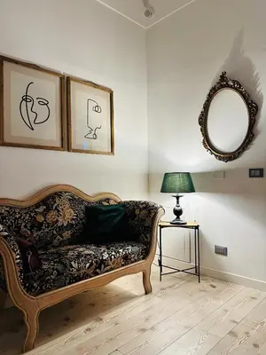 a living room with a couch and a mirror at Maison Opéra in Palermo