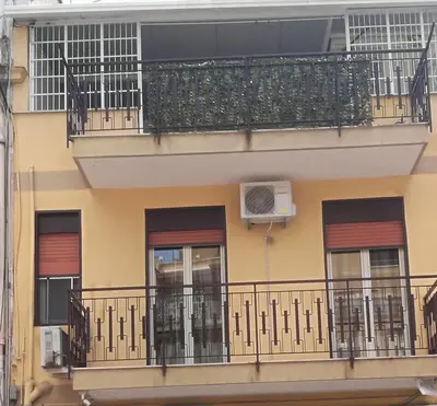 an apartment building with a balcony with a air conditioner at La Casa di Peppe in Capaci