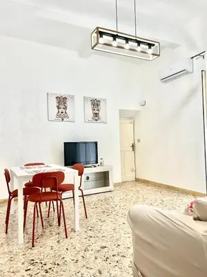 a living room with a table and chairs and a tv at Casa Repasi in Sferracavallo