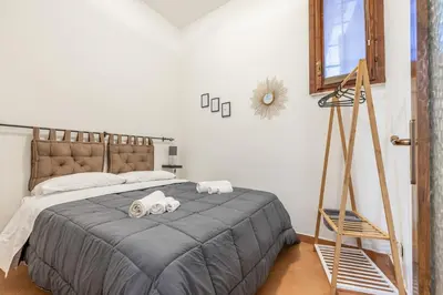a bedroom with a bed with two towels on it at Sicilia Bella Maqueda in Palermo