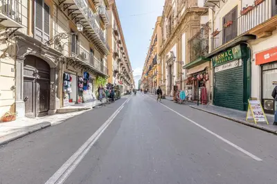 an empty street in a city with buildings at Sicilia Bella Maqueda in Palermo