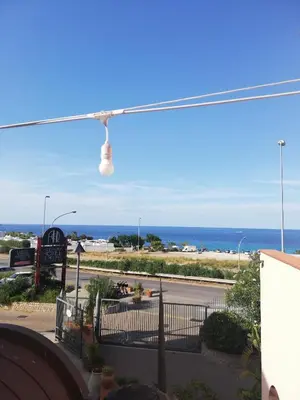 a view of a beach with the ocean in the background at 215 addaura luxury room in Palermo