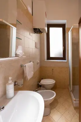 a bathroom with a toilet and a sink and a tub at Hola Cathedral House Cadorna in Palermo