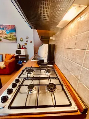 a kitchen with a stove top in a kitchen at Hola Cathedral House Cadorna in Palermo