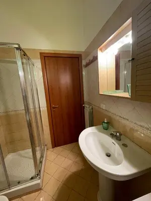a bathroom with a sink and a shower at Hola Cathedral House Cadorna in Palermo
