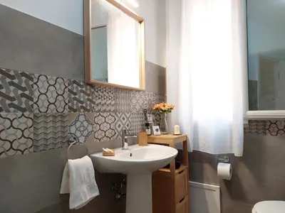 a bathroom with a sink and a mirror at Sunset House in Balestrate