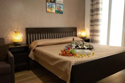 a bedroom with a bed with two lamps on it at Sunset House in Balestrate