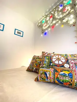 a bed with two pillows in a room at Casa Luminaria in Palermo