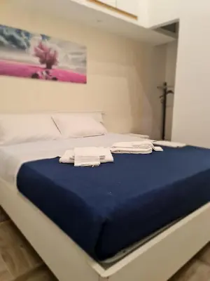 a bed in a room with two towels on it at Casa mulini in Palermo