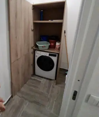 a small kitchen with a washing machine in a room at Casa mulini in Palermo