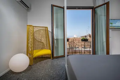 a beach with a group of people in the water at BED 10.5 - DESIGN SUITE in Castellammare del Golfo