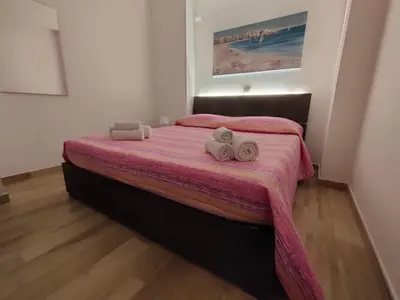 a bedroom with a bed with two towels on it at Les Voiles in Terrasini