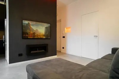 a living room with a couch and a painting on the wall at Politeama Centre in Palermo