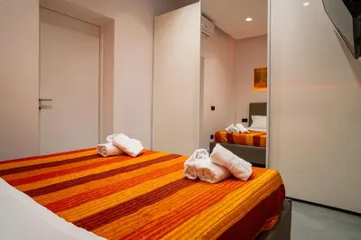 a bedroom with two beds with towels on them at Politeama Centre in Palermo