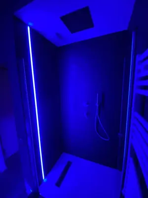 a bathroom with a blue light in a room at Politeama Centre in Palermo