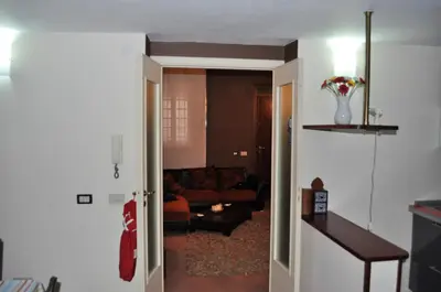 a hallway to a living room with a couch at Kalza House in Palermo