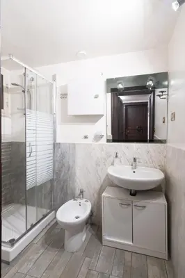 a bathroom with a sink and a toilet and a shower at Corner Rome 433 in Palermo