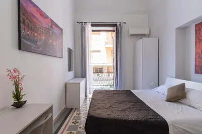 a small bedroom with a bed and a window at Corner Rome 433 in Palermo