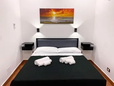 a bedroom with a bed with two towels on it at Aliva room LT in Palermo