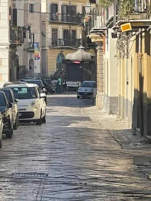 a city street with cars parked on the street at A casa di ilary in Palermo