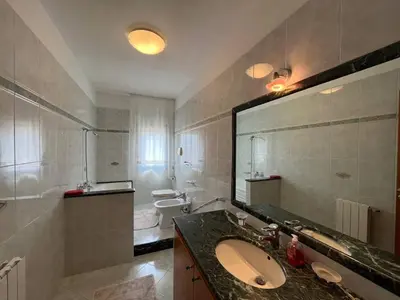 a bathroom with a sink and a large mirror at Appartamento Gemma D'oro in Castellammare del Golfo