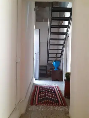 a hallway with a staircase and a rug on the floor at Domus 31 in Palermo