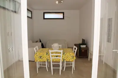 a dining room with a table and chairs in a room at Villa Fede & Niki in San Vito lo Capo
