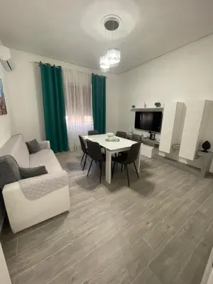 a living room with a couch and a table with chairs at OUR BEAUTIFUL SICILY in Palermo