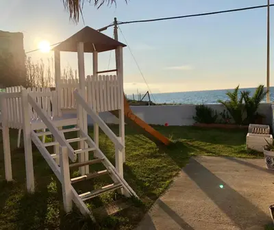 a playground with a slide in a yard at Case Playa in Balestrate