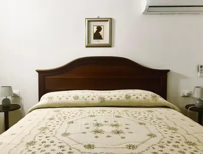 a bedroom with a bed with a blanket on it at Itaca in Palermo