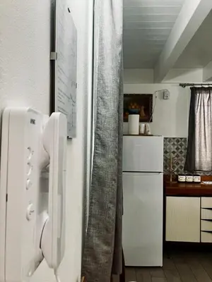 a kitchen with a white refrigerator in a room at Itaca in Palermo