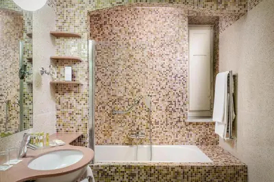 a bathroom with a sink and a bath tub at Eurostars Centrale Palace Hotel in Palermo