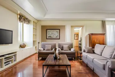 a living room with two couches and a coffee table at Eurostars Centrale Palace Hotel in Palermo