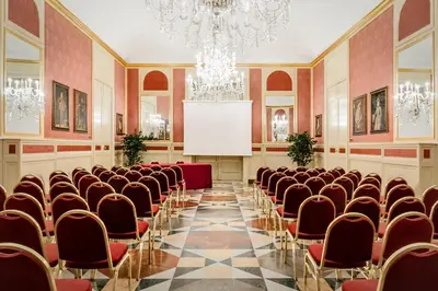 a large room with chairs and a screen in it at Eurostars Centrale Palace Hotel in Palermo