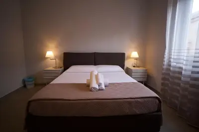 a bedroom with a bed with two stuffed animals on it at Donna Franca Rooms and Suite in Palermo