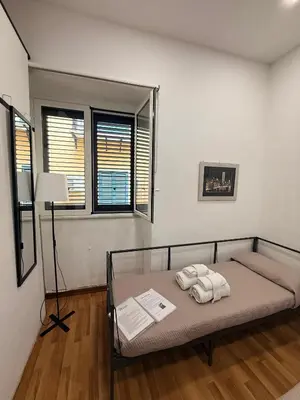 a bedroom with a bed with two towels on it at Casetta Mape in Palermo