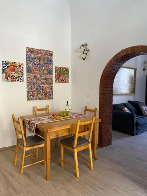 a dining room with a table and two chairs at Casa in piazzetta in Balestrate