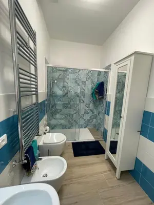 a bathroom with two sinks and a shower and a toilet at Casa in piazzetta in Balestrate