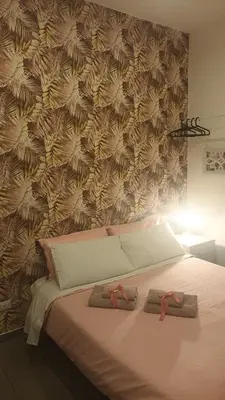a bedroom with a bed with two slippers on it at Affittacamere Ammirata in Palermo