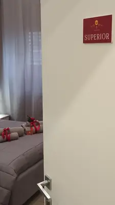 a row of beds in a room with a sign at Affittacamere Ammirata in Palermo