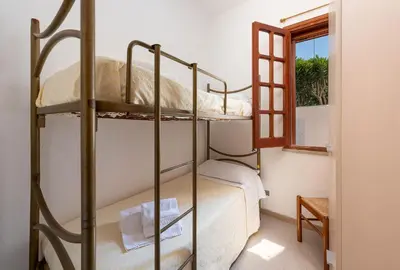 a room with two bunk beds and a window at Casa Vacanza Azzurra 2 in San Vito lo Capo