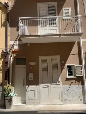 an apartment building with a balcony and a door at Denise Vacanze - Monolocali arredati in Bagheria