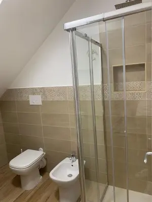 a bathroom with a toilet and a shower at Denise Vacanze - Monolocali arredati in Bagheria