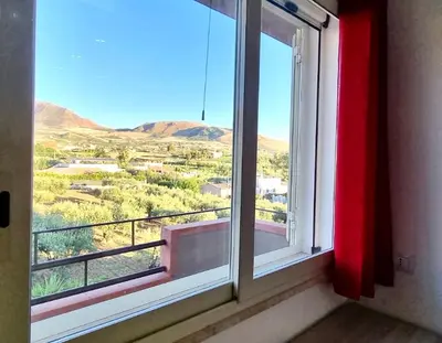 a window with a view of a mountain view at B&B Torre Turrisi in Partinico
