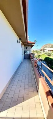 a balcony of a building with wooden benches at B&B Torre Turrisi in Partinico