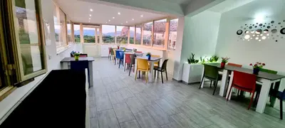 a restaurant with tables and chairs and windows at B&B Torre Turrisi in Partinico