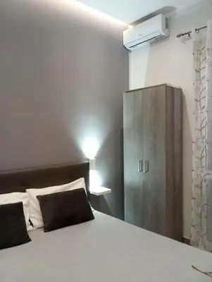 a bedroom with a large bed and a cabinet at Goccia del mare in Isola delle Femmine