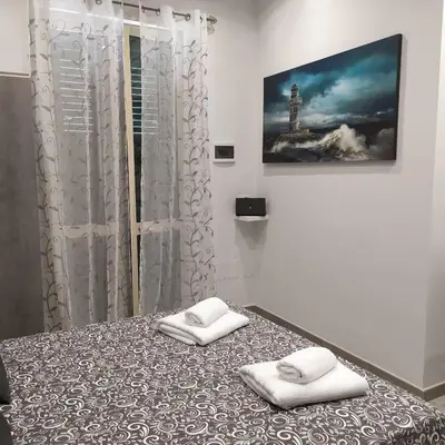 a bedroom with a bed with two towels on it at Goccia del mare in Isola delle Femmine